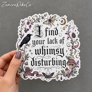 May include: A die-cut sticker featuring the black text I find your lack of whimsy disturbing in a gothic font. The design is surrounded by illustrations of a black crow, a moth, a snail, a mushroom, a beetle, stars, and a crescent moon.