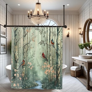 May include: A shower curtain featuring a forest scene with birch trees, a flowing stream, and songbirds perched on branches. The curtain has a soft green and white color palette with touches of pink blossoms, creating a serene and natural aesthetic.