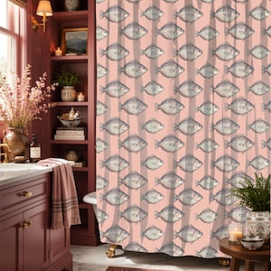 May include: A shower curtain featuring a repeating pattern of black and white fish illustrations set against a soft pink background with vertical, muted brown stripes. The fabric hangs from a rod with rings, displaying a consistent fish motif.