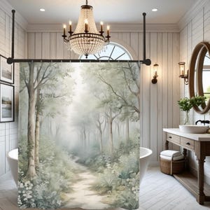 May include: A watercolor-style shower curtain featuring a serene forest scene with a path winding through trees. The curtain is predominantly green and gray, creating a calming, natural aesthetic. The bathroom also includes a white bathtub, a wooden vanity, and a crystal chandelier.