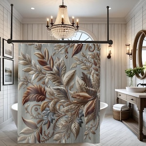 May include: A shower curtain with a detailed botanical design in shades of brown, beige, and gray. The floral pattern features leaves and vines, creating a textured, three-dimensional effect. The curtain hangs in a bathroom with a chandelier and a wooden vanity.