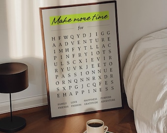 Può includere: Un puzzle di ricerca di parole incorniciato con il testo "Make more time for" in stile scritto a mano. Il puzzle include parole come "Adventure" e "Happiness". Una tazza di caffè è su un libro con arte floreale.