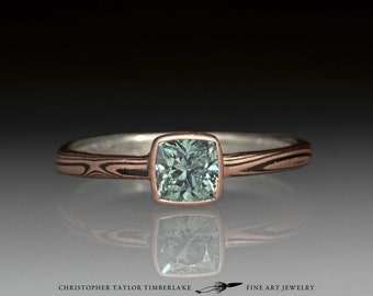 Mokume Gane 14K Rose Gold and Oxidized Sterling Silver Ring with Green-Teal Cushion Montana Sapphire