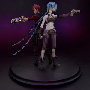 May include: A 3D-printed figurine featuring two characters with weapons. One character has red hair and a red jacket, while the other has blue hair and a black top. Both are posed with their arms outstretched, holding their weapons.