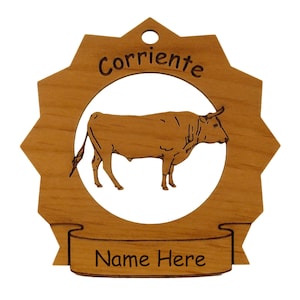 May include: Wooden ornament with a starburst shape, featuring a cutout of a bull inside a circle. The word "Corriente" is above the circle, and "Name Here" is below. The ornament is made of light brown wood.