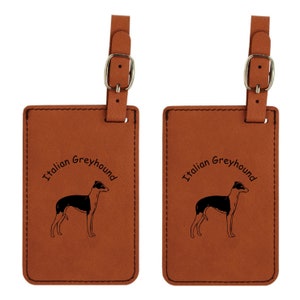 May include: Two brown leather luggage tags with a strap and buckle. Each tag features a black and white illustration of an Italian Greyhound and the words "Italian Greyhound" in a curved font.