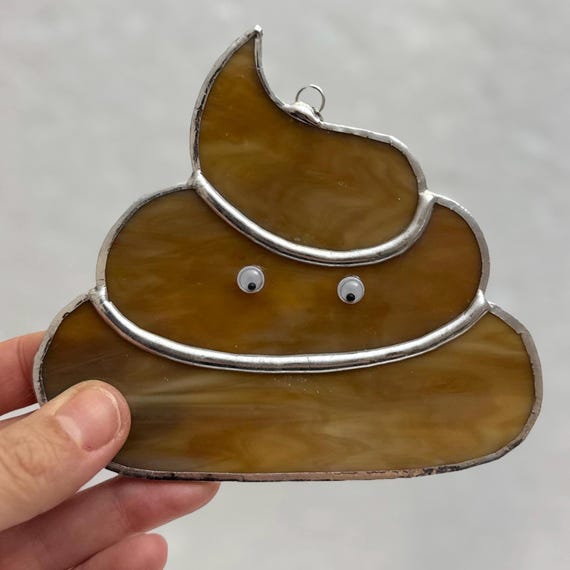 Someone cut and soldered real stained glass into a poop emoji — the collision of a medieval craft and a dumb meme is genuinely hilarious and one-of-a-kind.