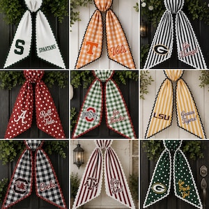 May include: A collection of nine decorative fabric door bows featuring various sports team logos and slogans. Each bow has two long, scalloped-edge tails with patterns including gingham, stripes, and polka dots in diverse team colors.