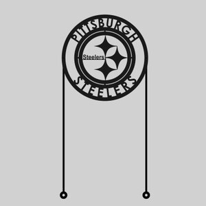 May include: Black metal Pittsburgh Steelers sign with the team logo and the words "Pittsburgh Steelers" in a circular design. The sign has two vertical lines extending downwards with small circles at the ends.