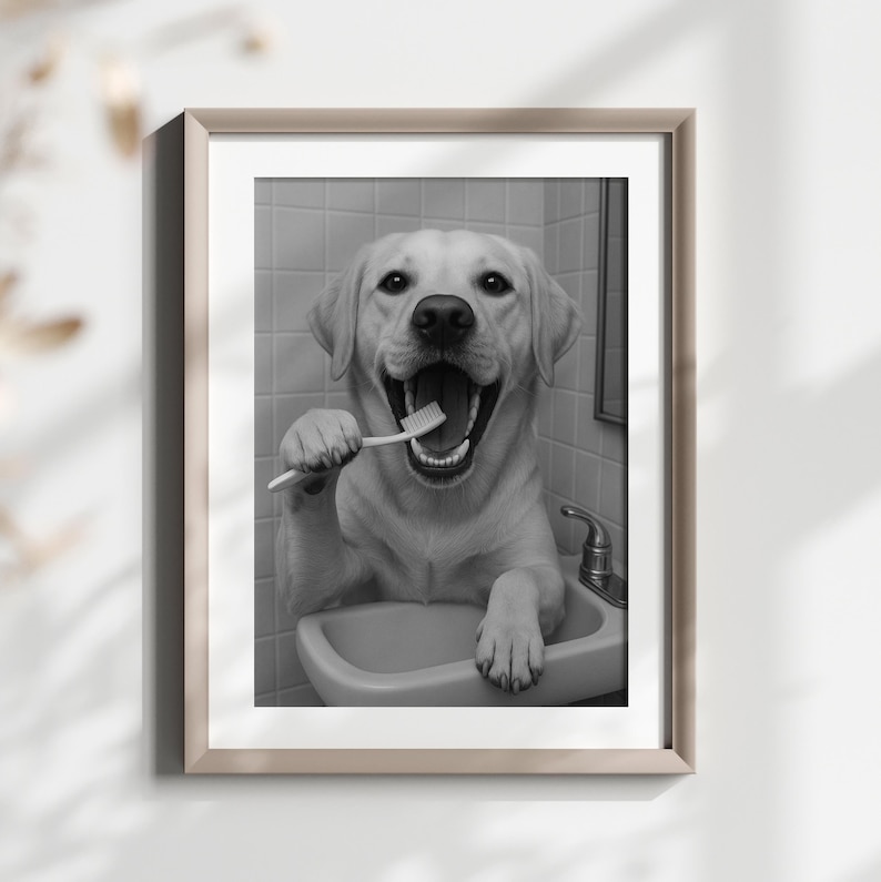 May include: Black and white framed print of a yellow Labrador Retriever dog brushing its teeth in a bathroom sink. The dog has its mouth open wide, holding a toothbrush. The image is in a bathroom setting.