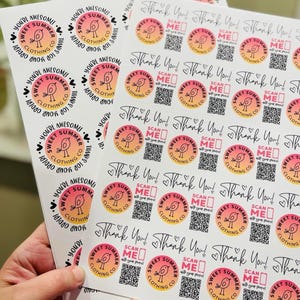 May include: A sheet of stickers with a pink and orange gradient design featuring a small bird and the text "Sweet Summer Clothing Co." and "You're Awesome!" Some stickers also have a QR code with the text "Scan Me!"