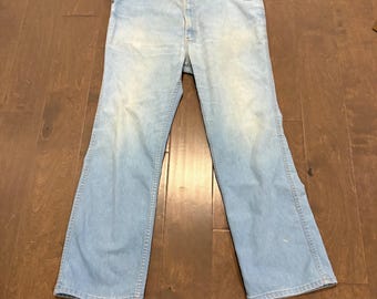 Jeans vintage Levi's con etichetta arancione, taglia 36x29, lavaggio chiaro, effetto consumato, modello Skosh a zampa.