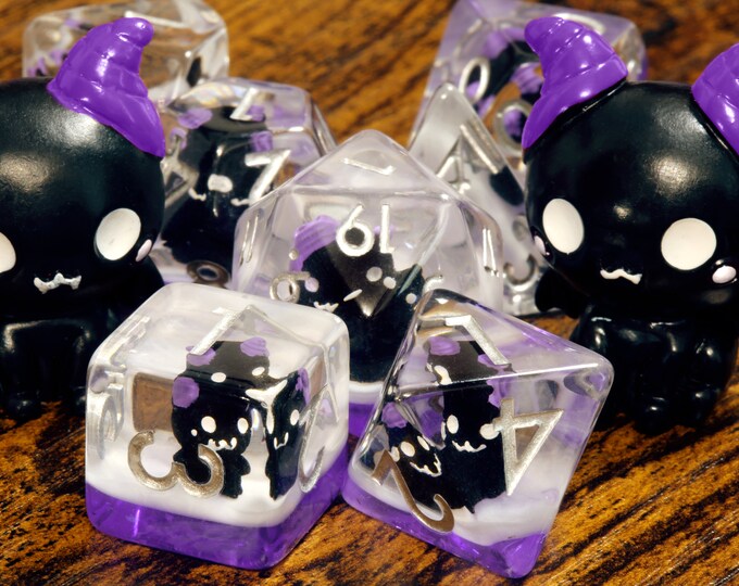 Eldritch Cat Dice Set Dice Set With Winged Cats on an Purple Layer
