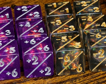 May include: Close-up of several dice, some purple and some black, with white and gold numbering. The dice have diagonal lines and numbers like +2, +6, -2, and -6. The dice are arranged on a wooden surface.