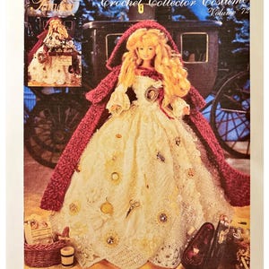 May include: A crochet pattern book cover featuring a doll in a cream-colored dress with a burgundy cape. The doll is adorned with embellishments and has long blonde hair. The text reads "Crochet Collector Costume Volume 72" and "1840 London Peddlar Lady".