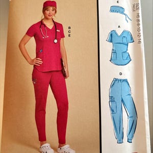 May include: McCall's sewing pattern for medical scrubs. The pattern includes a scrub top, pants, and cap. The image shows a woman wearing a red scrub set with a stethoscope. The pattern is designed and printed in the USA.