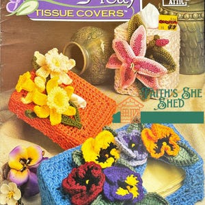 May include: Crochet tissue box covers with floral designs. The covers are made in blue, orange, and white with pink, yellow, and purple flowers. The title "Petal Pretty Tissue Covers" is on the cover.