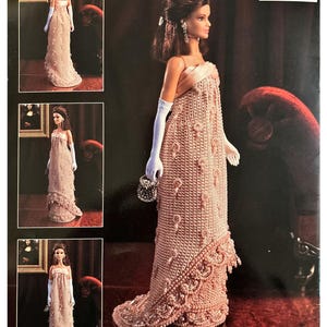 May include: A Barbie doll wearing a peach-colored crocheted gown with white gloves and a small beaded purse. The dress features intricate detailing and a flowing skirt. The image is on a black background with additional images of the doll.