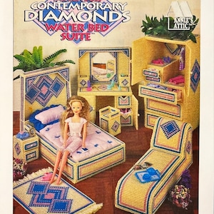 Peut inclure: Un livret de modèles de canevas en plastique intitulé Contemporary Diamonds Water Bed Suite par Annie's Attic. La couverture présente un ensemble de chambre de poupée en canevas jaune, bleu et rose, incluant un lit, une coiffeuse et une armoire.
