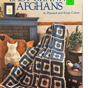 May include: A crochet pattern booklet for Lacy Granny Afghans in planned and scrap colors. The cover features a blue and white crocheted afghan draped over a chair.