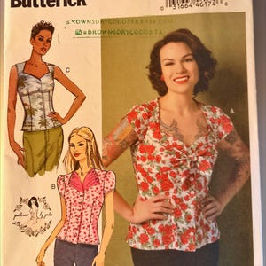 May include: Butterick sewing pattern B6217 featuring a woman in a floral top. The pattern includes illustrations of different top styles, with the text "ROWNSDRYGOODSTX.ETSY.COM" and "BROWNSDRYGOODS.TX" visible.