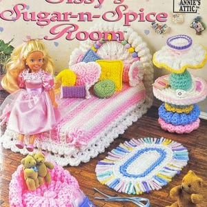 May include: A crochet pattern book cover titled "Sissy's Sugar-n-Spice Room" featuring a doll, miniature furniture, and accessories. The cover includes a doll in a pink dress, a bed, a rug, and a chair, all crocheted.