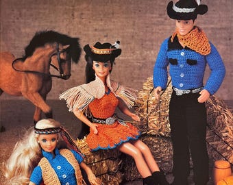 May include: Crochet doll pattern for Western wear. The pattern includes instructions for making a cowboy doll, a cowgirl doll, and a horse. The dolls are wearing crocheted outfits in blue, orange, and brown. The pattern is from Annie's Attic.