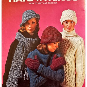 May include: A vintage knitting pattern booklet titled "Hats 'n Things: Easy to Knit and Crochet" featuring three women wearing knitted hats, scarves, and mittens. The booklet is from Columbia-Minerva Leaflet 2623.