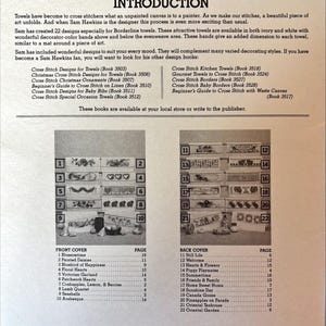 May include: A vintage book cover with a list of cross-stitch towel designs. The cover features a list of designs and a grid of small images. The book is from 1989 and published by the American School of Needlework.