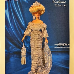 May include: A book cover featuring a doll in a beaded gown. The text reads "Crochet Collector Costume Volume 83" and "1905 Contessa's Crystal Gown." The doll has blonde hair and is wearing a tiara and holding a beaded purse.