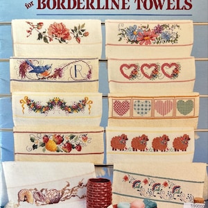 May include: A collection of cross-stitch designs for borderline towels. The designs include floral patterns, a bluebird, hearts, sheep, and seashells. The text "Sam Hawkins Designs Cross Stitch" and "BORDERLINE TOWELS" are visible.