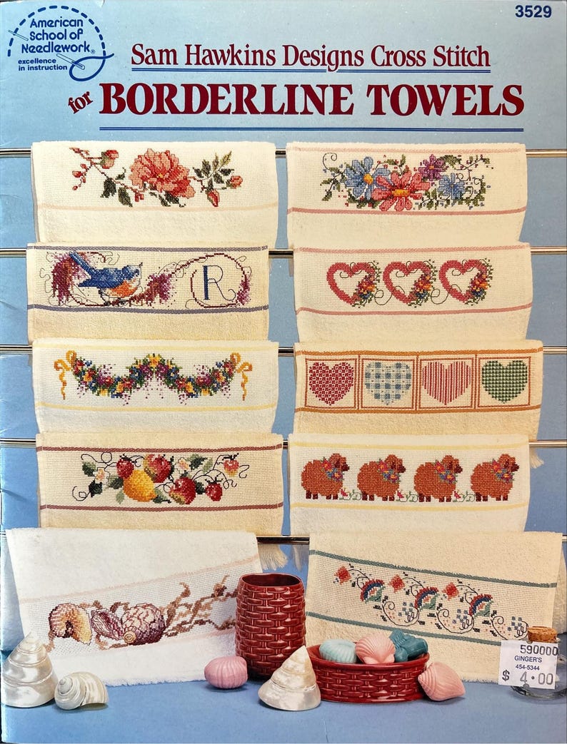 May include: A collection of cross-stitch designs for borderline towels. The designs include floral patterns, a bluebird, hearts, sheep, and seashells. The text "Sam Hawkins Designs Cross Stitch" and "BORDERLINE TOWELS" are visible.