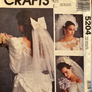 May include: A vintage McCall's Crafts pattern envelope featuring bridal designs. The cover showcases a bride in a white wedding dress with lace details and a veil. The envelope includes the text "Alicyn Exclusives" and "5204".