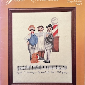 May include: A cross-stitch pattern book titled "Jessa Counts..." features a framed image of three men and a dog, with musical notes below. The text reads "My wild Irish rose, the sweetest flow'r that grows." The book is from Jessa Needlecrafts International 1982.