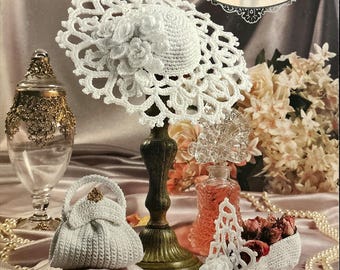 May include: A white crocheted wedding slipper, hat, and purse. The items are part of the Annie's Miniature Shoe Society collection. The text "Stepping Through Time Collection" and "Wedding Slipper" are visible on the image.