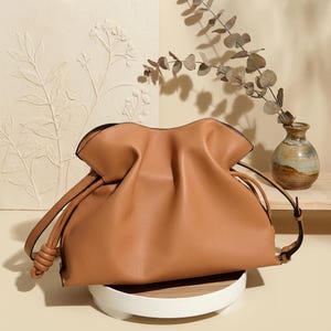 Premium leather cloud bag with magnetic buckle closure. Soft, minimalist design in elegant horizontal square shape. Perfect luxury shoulder bag for work or special occasions. Versatile crossbody messenger. Thoughtful gift for her.