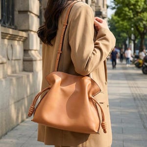 Premium leather cloud bag with magnetic buckle closure. Soft, minimalist design in elegant horizontal square shape. Perfect luxury shoulder bag for work or special occasions. Versatile crossbody messenger. Thoughtful gift for her.