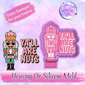 May include: Pink and white nutcracker design with the text "YA'LL ARE NUTS". The image also includes a color example and a silicone mold. The nutcracker has heart-shaped eyes and a crown.