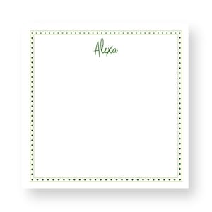 May include: A white notepad with a green dotted border and the name "Alexa" written in green cursive.