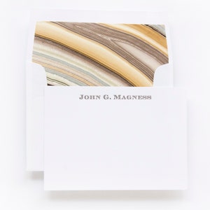 May include: A white envelope with a marbled paper liner. The envelope has a return address that reads "JOHN G. MAGNESS".