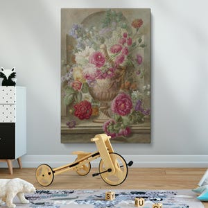 May include: A vintage-style painting of a vase filled with pink, white, and red flowers. The vase is ornate and sits on a ledge. The painting is in a light brown frame.