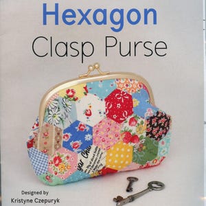 May include: A colorful hexagon clasp purse with a gold-toned frame. The purse is made of patchwork fabric with floral and polka dot patterns. The image includes the text "Hexagon Clasp Purse" and "Hardware Included".