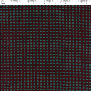 May include: A close-up of a fabric with a repeating pattern of teal blue polka dots on a maroon background.