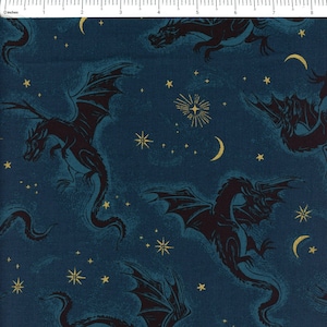 May include: A dark blue fabric featuring a repeating pattern of black dragons with teal highlights, interspersed with gold stars and crescent moons. A ruler at the top edge shows the scale in inches, with the pattern spanning approximately 9 inches.