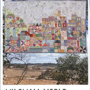 May include: A colorful quilt with a cityscape design, featuring houses, rainbows, and geometric patterns. The quilt is displayed outdoors with a landscape backdrop and the text "MY SMALL WORLD" at the bottom. The quilt is made of various fabric scraps.