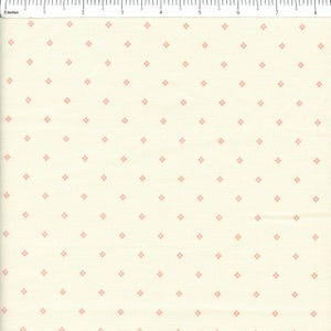 May include: Cream-colored fabric with a repeating pattern of small, light red diamond shapes. The diamonds are evenly spaced across the surface. The fabric has a subtle texture, and a ruler is visible along the top edge, indicating measurements in inches.