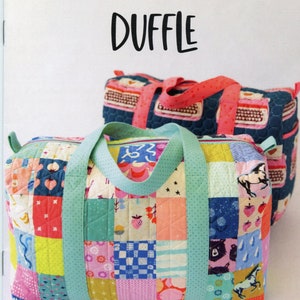 May include: Two patchwork duffle bags with colorful square patterns. The front bag has light blue handles and a variety of squares with images of strawberries, horses, and bears. The text "PATCHWORK DUFFLE" is at the top.
