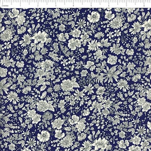 May include: Close-up of a fabric with a dense floral pattern. The design features numerous white flowers and foliage against a deep navy blue background. The flowers vary in size and shape, creating a textured, all-over print.