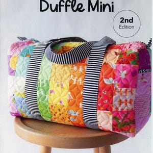 May include: A colorful patchwork duffle bag with a striped handle and accents. The bag is made of quilted fabric in a variety of colors and patterns, including floral and geometric designs. The text "Patchwork Duffle Mini" is at the top.