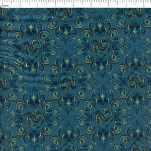 May include: A teal fabric featuring a repeating damask pattern with gold-colored dragon silhouettes centered within each motif. A white ruler at the top edge shows the scale in inches, with the pattern repeating across approximately 8 inches.